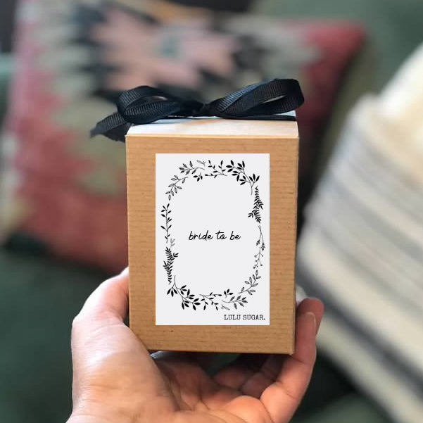 hand holding bride to be boxed candle